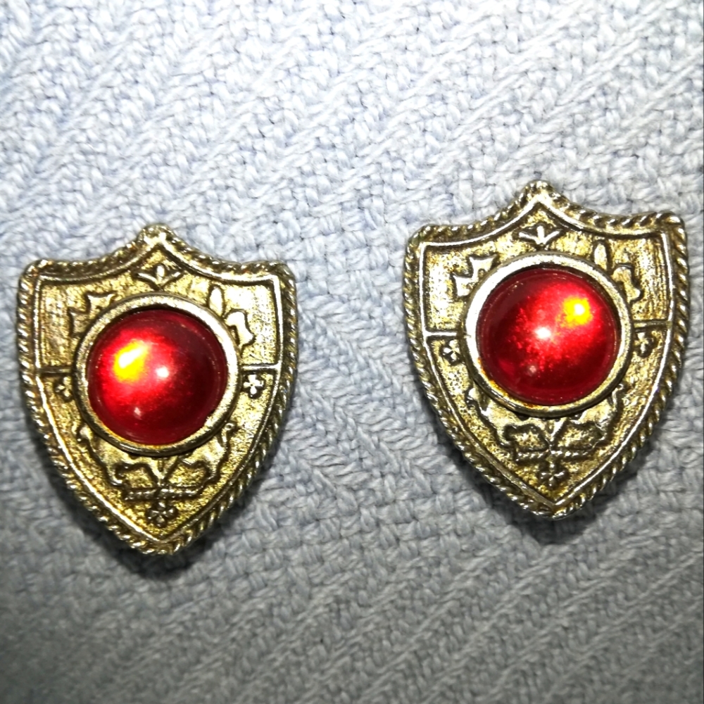 Clip-on earrings Silver shield with red jewel center